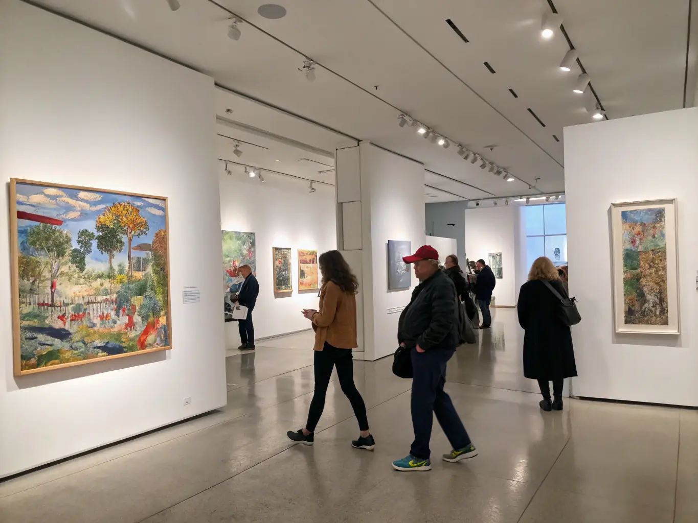 A captivating image of a contemporary art exhibition at 26 LE HANGAR, featuring a diverse collection of paintings, sculptures, and mixed-media installations.
