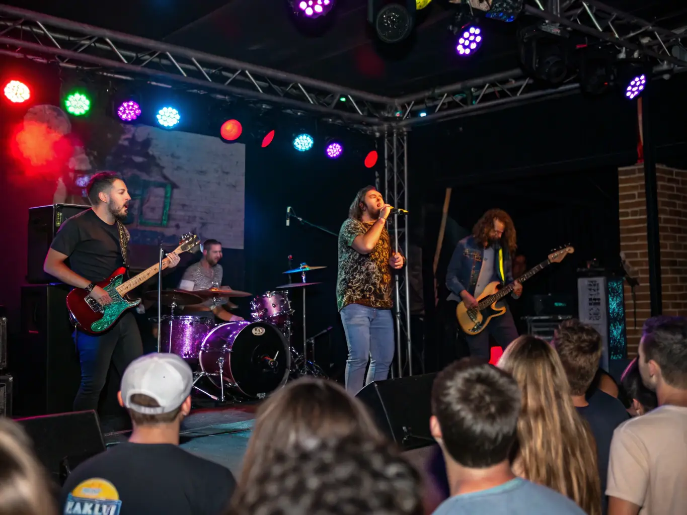 A captivating photograph of a live music performance during a cultural event at 26 LE HANGAR, capturing the energy and excitement of the audience.